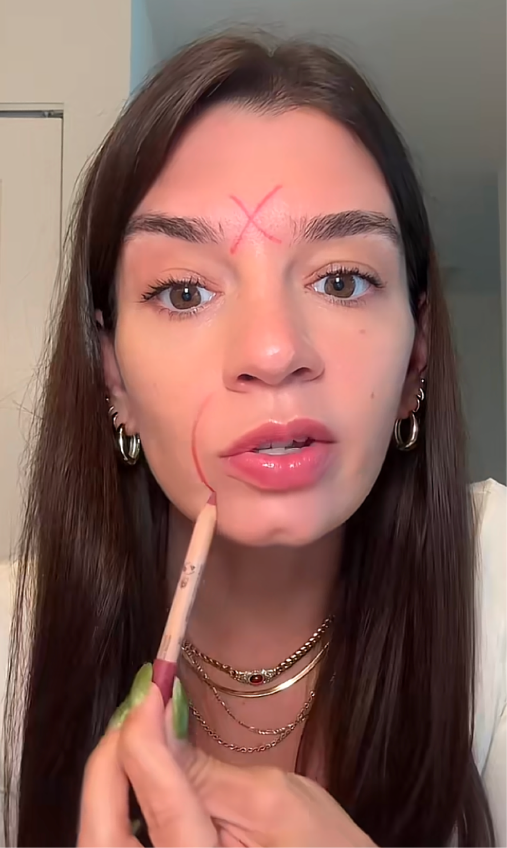 Creator drawing directly on the face to show concern lines